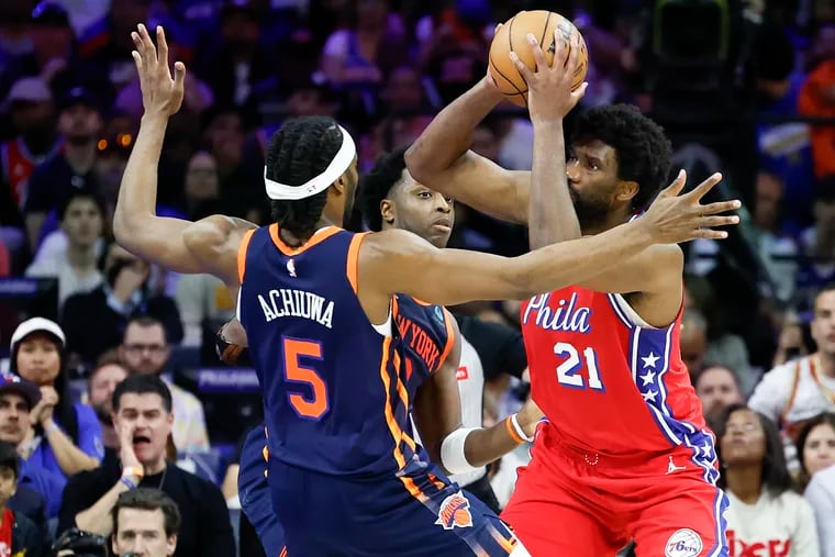 Sixers center Joel Embiid gets double teamed against New York Knicks forward’s Precious Achiuwa and OG Anunoby during in the fourth quarter in Game 4 of the first round NBA Eastern Conference playoffs on Sunday, April 28, 2024 in Philadelphia.