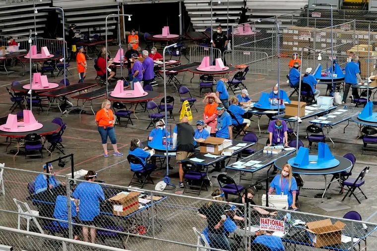 Maricopa County ballots cast in the 2020 general election are examined and recounted by contractors working for Florida-based company Cyber Ninjas at Veterans Memorial Coliseum in Phoenix last month.