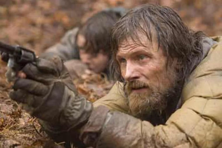 In this film publicity image, Viggo Mortensen, right, and Kodi Smit-McPhee are shown in a scene from "The Road." (AP Photo/The Weinstein Company, Macall Polay)