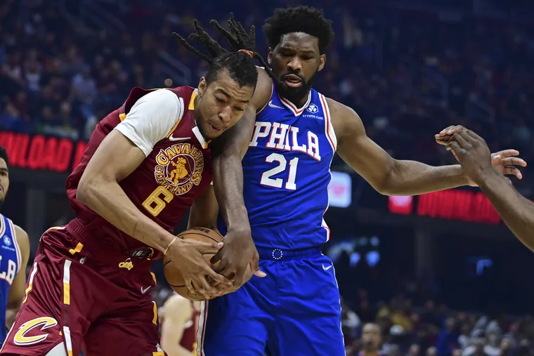 Cleveland Cavaliers center Moses Brown (6) rebounds against Philadelphia 76ers center Joel Embiid (21) in the first half of an NBA basketball game, Sunday, April 3, 2022, in Cleveland.
