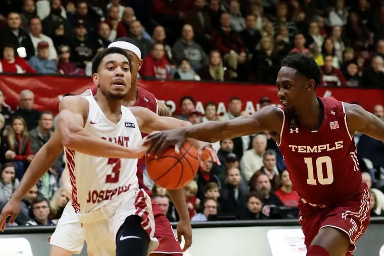 Saint Joseph's guard Jared Bynum gets fouled against Temple guard Shizz Alston Jr., during the first-half on Saturday, December 1, 2018.  YONG KIM / Staff Photographer