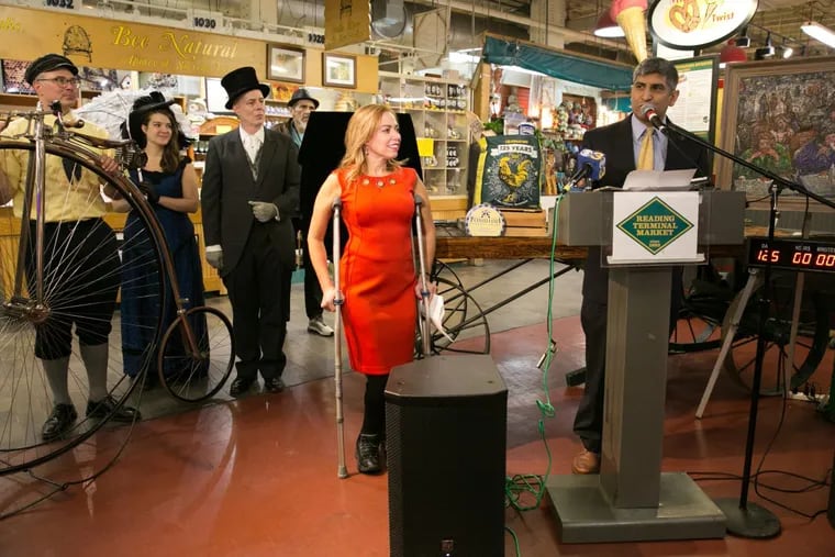 City Representative Sheila Hess (left) stands by as Anuj Gupta,  general manager of Reading Terminal Market, announces plans for the market’s  125th birthday celebration at a news conference on Friday.
