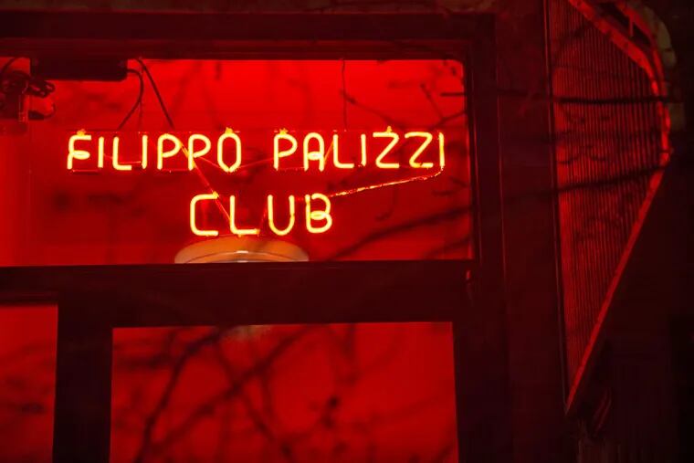 The red neon sign over the front door of the Palizzi Social Club.