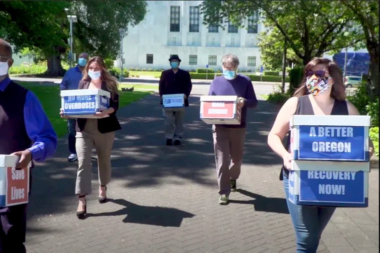 Volunteers deliver boxes of signed petitions in favor of Measure 110 to the Oregon Secretary of State’s office in June. The measure, which passed on Election Day, decriminalizes possession of small amounts of heroin, cocaine, LSD, and other drugs.