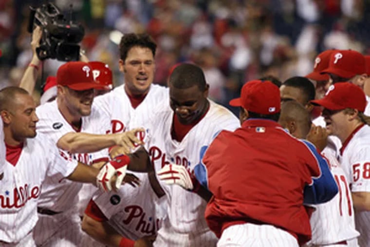 Phillies&#0039; Ryan Howard celebrates his game-winning, two-run home run with his teammates in the 14th.