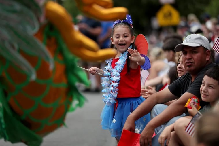 Aylin Gomez, 5, of Kennett Square, waves at participants in the Kennett Square Memorial Day Parade in Kennett Square, Pa. on Monday, May 29, 2023. 