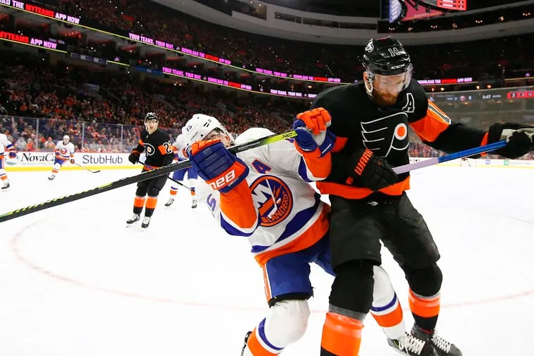 Flyers center Sean Couturier (right) and New York Islanders right winger Cal Clutterbuck battle for position in an early-season game. The teams will meet in the conference semifinals starting Monday in Toronto.