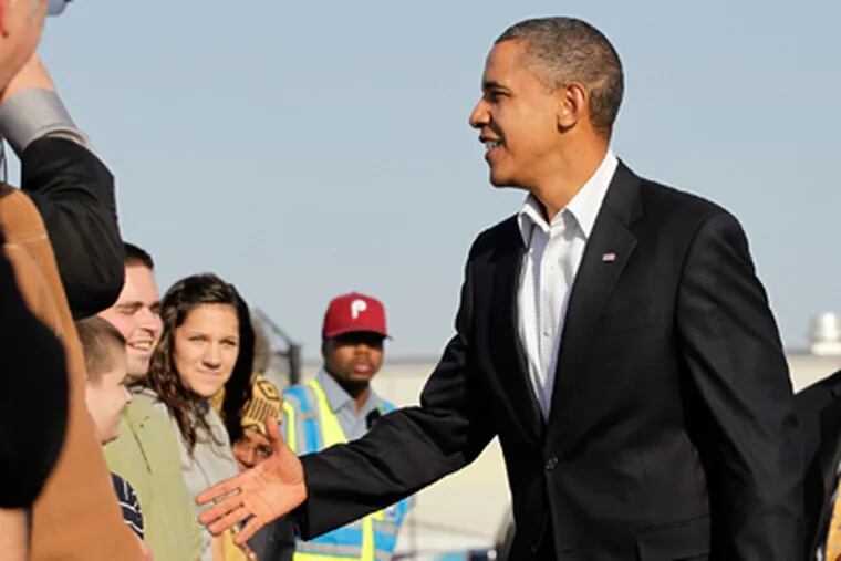 President Barack Obama shakes hands with greeters at the Philadelphia International Airport as he arrives to rally supporters before the midterm election on Sunday. (AP Photo/J. Scott Applewhite)