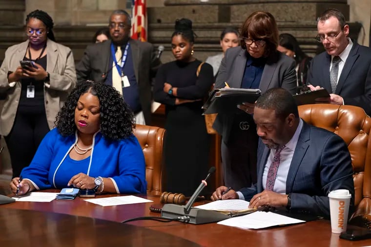 Philadelphia City Council president Kenyatta Johnson (right) and  majority leader  Katherine Gilmore Richardson go over bills and resolutions as they meet in caucus with other councilmembers Jan. 25. Gilmore Richardson intends to introduce legislation that would change how the city contracts with nonprofits.