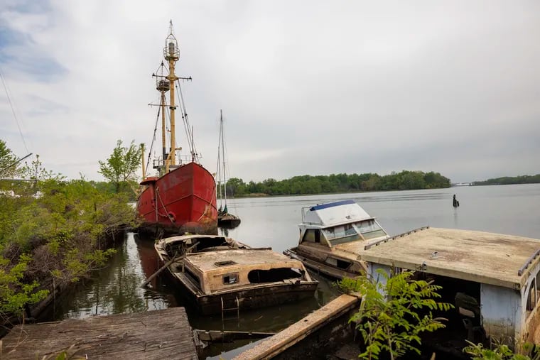 Derelict boats and the imposing hulk of the Light Ship Barnegat are docked at the former Pyne Poynt Marina in North Camden. Longtime owners Annie Sadler and her family recently sold the property to Camden County, which will incorporate the wooded and scenic site on the Delaware River's back channel into the county park and trail system. Photo taken during tour of grounds on Wednesday, April 26, 2023.