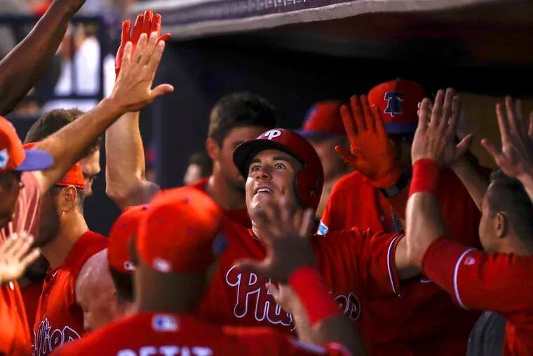 Phillies J.T. Realmuto celebrates with his teammates after hitting a solo home run.