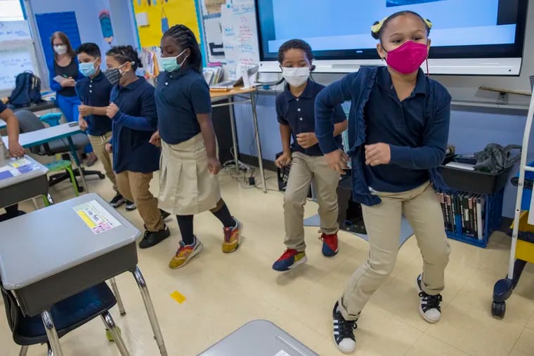 Yurielys Rodriguez, third grader, shows her salsa moves at Juniata Park Academy on Friday, Oct. 8, 2021. As Philly families prepare for students to return to schools after the holidays, concerns about COVID-19's omicron variant are high.