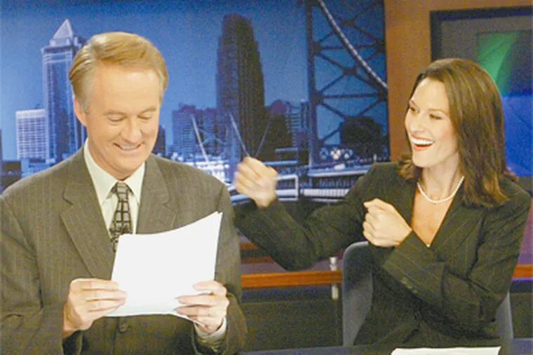 Alycia Lane throws a mock punch at then co-anchor Larry Mendte when they hosted the CBS3 local newscast together. (Daily News file photo)