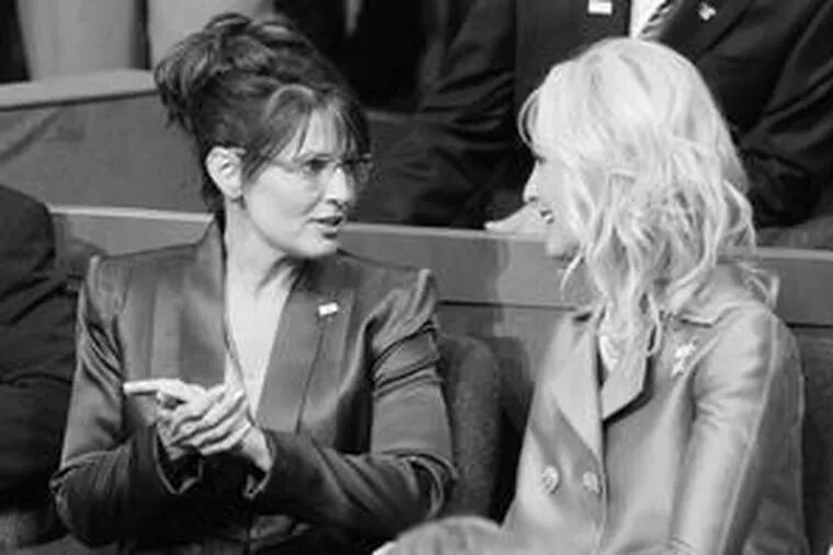 Republican vice-presidential nominee Sarah Palin (left) speaks with Cindy McCain, wife of Republican presidential candidate John McCain, at the convention last night.