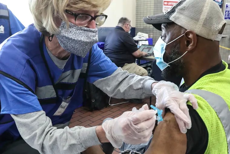 Nurse Michaelle Rennix gives Christian Rivers a SEPTA worker the single-dose Johnson & Johnson vaccine at SEPTA’s 69th Transportation Center in Upper Darby on May 13.