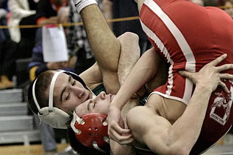 West Deptford's Drew Spector (left) pins Paulsboro's Mike Silvestro for his 100th career win. ( Elizabeth Robertson/Staff Photographer )