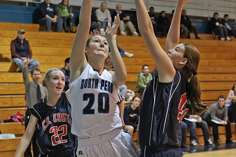 North Penn's #20, Lauren Crisler, center, shoots over Central Bucks
East's Courtney Webster, right, in the first quarter. Central Bucks
East plays at North Penn in girls' basketball, 7 p.m.  SNPENN22
12/21/2012 ( MICHAEL BRYANT / Staff Photograher )