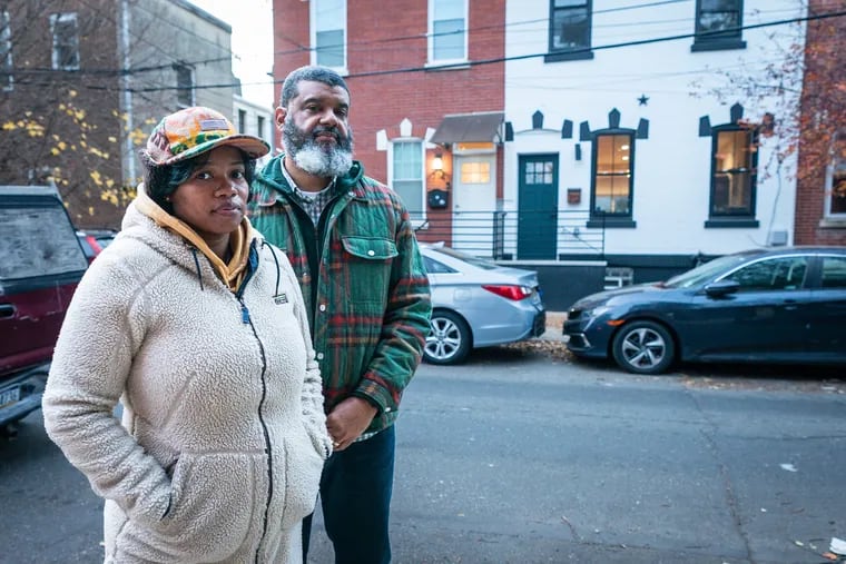 Najah Queen and her husband, Shane Randall, in front of Randall's childhood home. In 2018, they were working toward renovating it to move their family in, but instead the home was placed in conservatorship and sold.