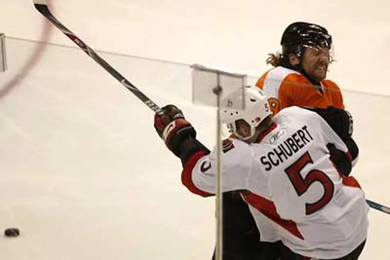 The Flyers' Scott Hartnell takes the Senators Christoph Schubert to the boards during the second period of the Flyers' 6-4 win on Tuesday. (Michael S. Wirtz / Staff Photographer)