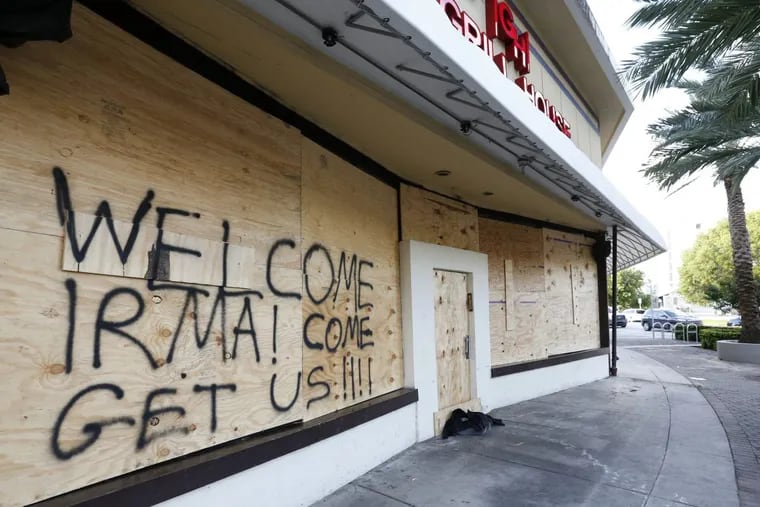 A boarded-up building bears a cheeky message for Irma  in Miami Beach, Fla.