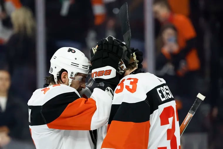 Flyers right wing Travis Konecny and goaltender Samuel Ersson celebrate after beating the New Jersey Devils 1-0 on Saturday.