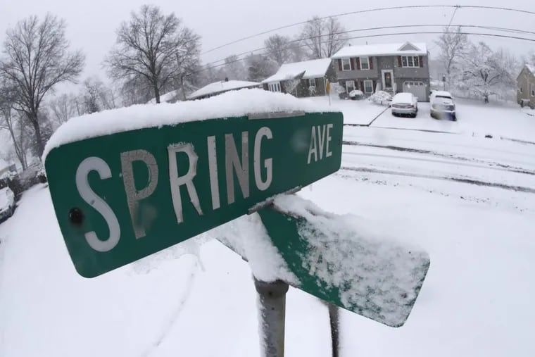 Snow rests on signs at the corner of Spring and Ritter avenues during a snowstorm, Wednesday, March 21, 2018, in South Plainfield, N.J. A spring nor'easter targeted the Northeast on Wednesday with strong winds and a foot or more of snow expected in some parts of the region.