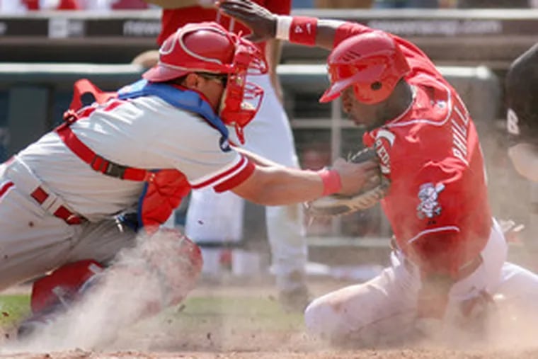 Phillies catcher Carlos Ruiz tags out Reds&#0039; Brandon Phillips in sixth inning.