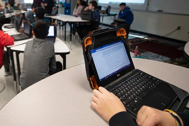 Seventh grader Luke Bonnes types on a computer during a class at Peirce Middle School in the West Chester Area School District Tuesday. West Chester is launching a new cyber school program next year in an attempt to bring students back into the district from cyber charters.