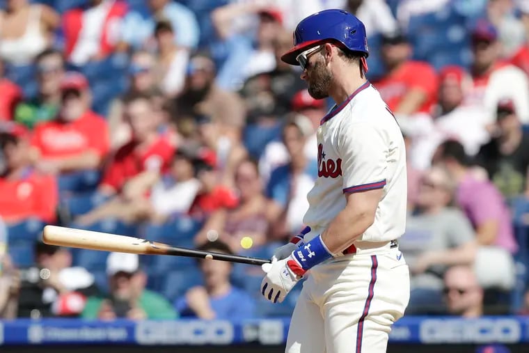 Phillies Bryce Harper looks at his bat after striking out to end the first inning against the Washington Nationals on Saturday, June 5, 2021. It was his first at-bat since returning from the injured list.