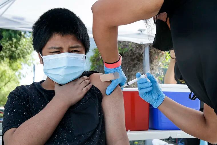 A 12-year-old receiving a COVID-19 vaccine at a Los Angeles mobile clinic in June 2021.