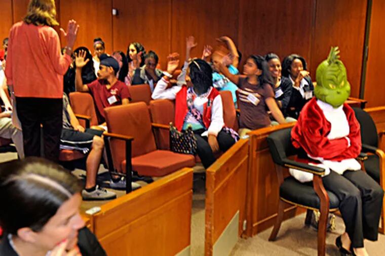 With the "Whoville Jury" out of the courtroom, students discuss deliberations.TOM GRALISH / Staff Photographer