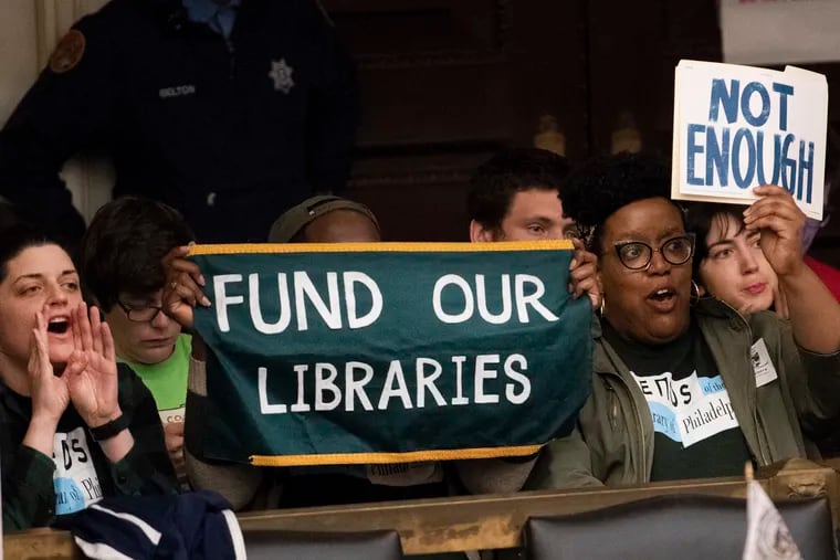 Free Library advocates show their support before City Council during a meeting at City Hall in April.
