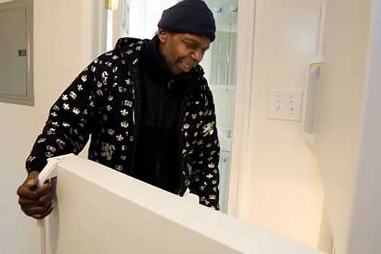 Robert Ford, a disabled truck driver living on the streets of Philadelphia, tours his new apartment obtained through the Pathways to Housing program. (Ed Hille / Staff Photographer)