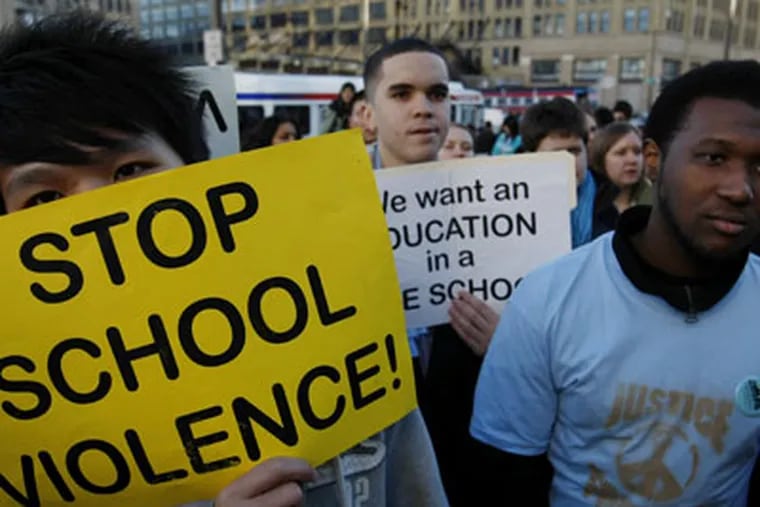 From left, South Philadelphia High School Student Jianbiao Xue, and Fels High School students Christian Dejesus and Aaron Neal listen were part of a march aimed at stopping school violence. ( Michael S. Wirtz / Staff Photographer ).