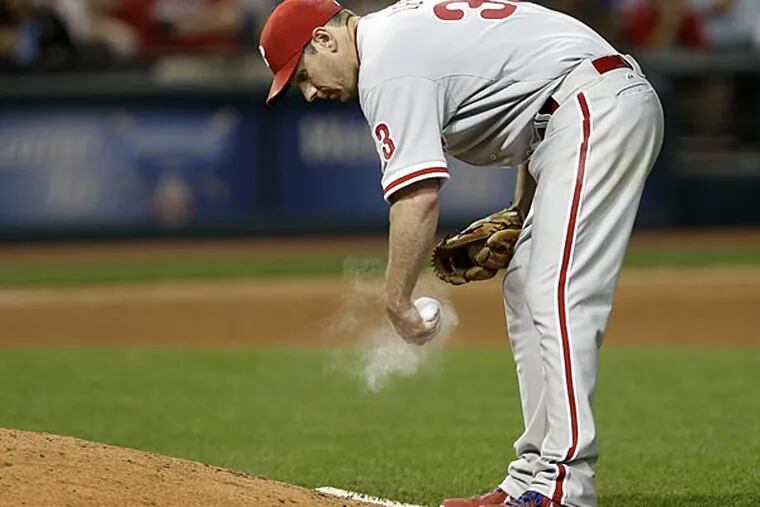 Philadelphia Phillies starting pitcher Cliff Lee works the rosin bag in the sixth inning of a baseball game against the Cleveland Indians, Wednesday, May 1, 2013, in Cleveland. (AP Photo/Tony Dejak)