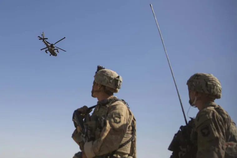 An AH-64 Apache attack helicopter provides security from above while CH-47 Chinooks drop off supplies to U.S. Soldiers with Task Force Iron at Bost Airfield, Afghanistan, June 10, 2017. The Soldiers are here to provide accurate fires capabilities in support of Task Force Southwest and Afghan National Defense and Security Forces during current operations. Task Force Southwest, comprised of approximately 300 Marines and Sailors from II Marine Expeditionary Force, are training, advising and assisting the Afghan National Army 215th Corps and the 505th Zone National Police.