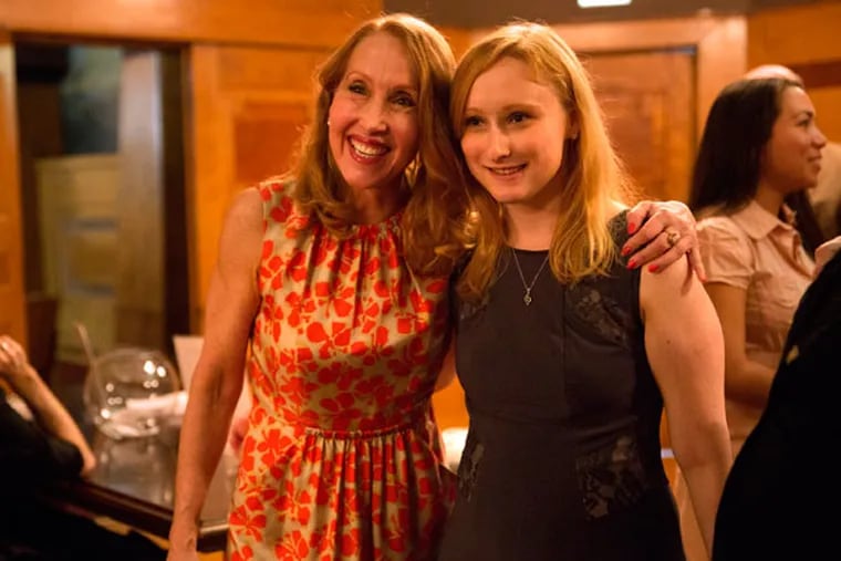 Rebecca Binkley, left, and daughter Kristina Cooper stand together after Kristina's senior violin recital at Roosevelt University in Chicago on Sunday, May 3, 2015. Kristina inherited a rare genetic disease from her mother, Ehlers-Danlos syndrome, which affects connective tissues in the body that support the skin, bones, blood vessels and other organs.