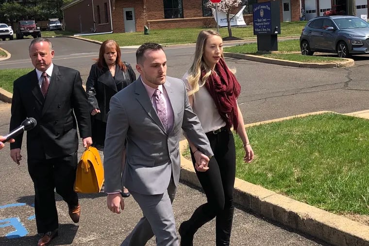 Matthew Aimers, center, walks into district court in Richboro holding hands with his wife, Kayla, in April 2019. Aimers was sentenced to six years' probation after being accused of sexually assaulting an underage waitress at his wedding reception in November 2018.