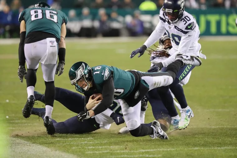 Eagles quarterback Josh McCown (18), center, dives to the sideline after running for a first down and setting up the Eagles for the field goal in the second quarter of the Eagles wild card playoff game against the Seattle Seahawks on January 5, 2020, at Lincoln Financial Field.