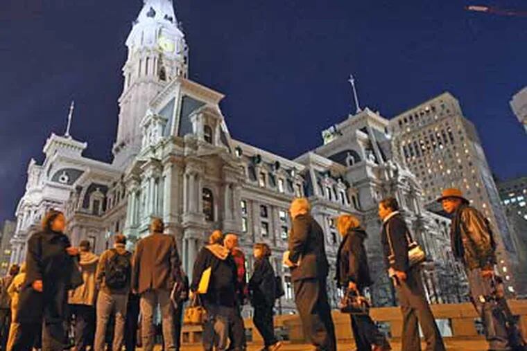 Throngs of Philadelphians wait in line outside City Hall to shake Michael Nutter's hand after he was sworn in as mayor last January.  (Michael Bryant / Staff File Photo)