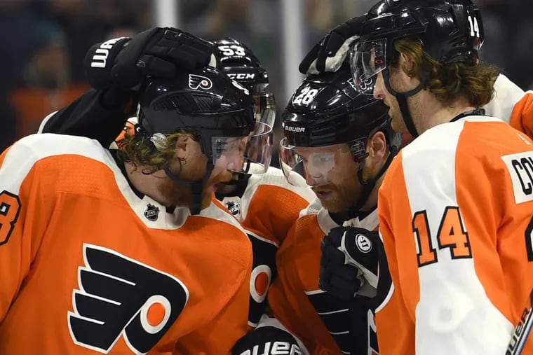 Flyers’ captain Claude Giroux, second from right, is congratulated by teammates Jakub Voracek, left, Shayne Gostisbehere and Sean Couturier (14) after scoring a goal against the Montreal Canadiens on Thursday.