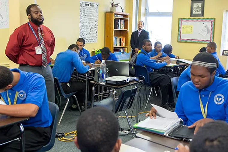 One Bright Ray Community High School teacher Kellen Massie (left) and Marcus A. Delgado, CEO (right) discuss the importance of staying positive with students after the School District cut the Sankofa Passages Program on September 17, 2014.  (Chanda Jones / Staff Photographer)