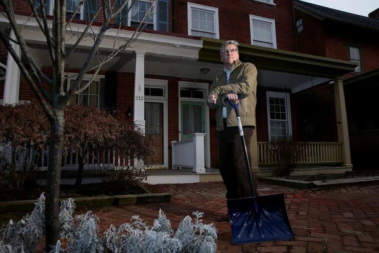 Ed Lotkowski outside his home in West Chester on Tuesday, Jan. 16, 2018. Lotkowski is outraged that the borough immediately initiates criminal court proceedings if someone is cited for not adequately shoveling their sidewalk. The pharmacist got a summons a few weeks ago.