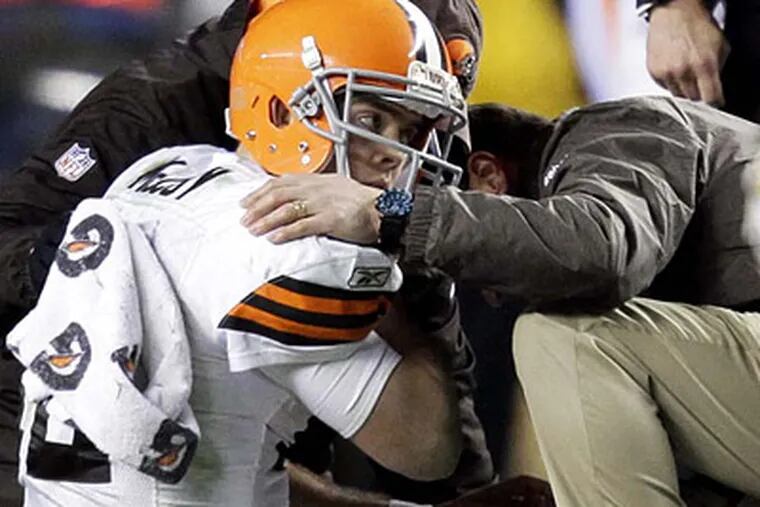 In this photo from Thursday, Dec. 8, 2011, trainers tend to Cleveland Browns quarterback Colt McCoy after he was hit by Pittsburgh Steelers outside linebacker James Harrison. (AP Photo/Gene J. Puskar)