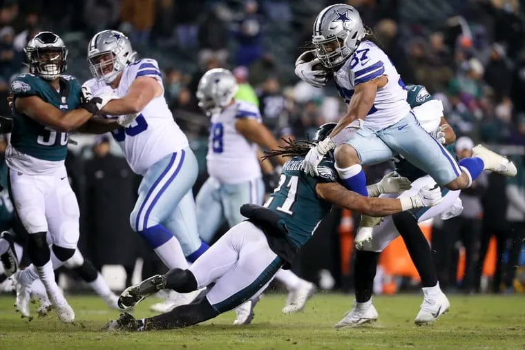 Dallas Cowboys running back JaQuan Hardy (37) leaps over Philadelphia Eagles defensive back Andre Chachere (21) Saturday, January 8, 2022 at Lincoln Financial Field in Philadelphia, Pa.