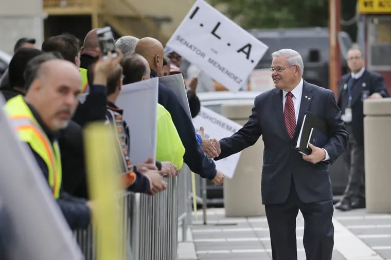 U.S. Senator Bob Menendez greets supporters as he arrives to court in Newark, N.J., on Monday.