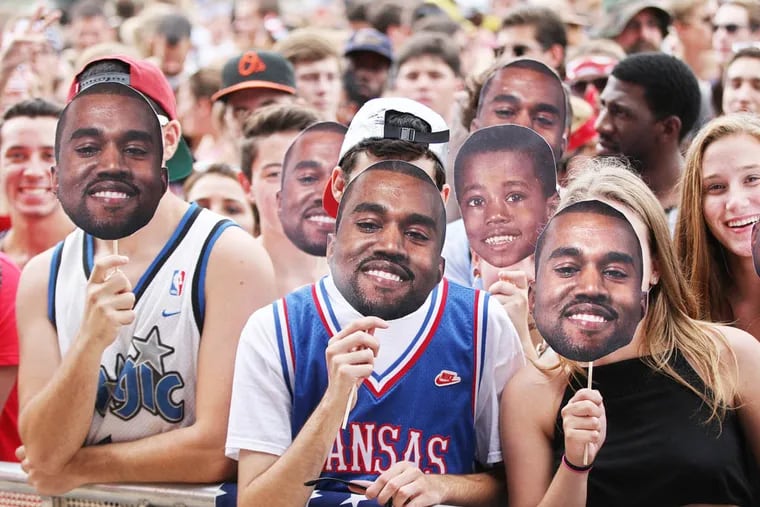 Members of the front row at the Rocky Stage pose with their Kanye West masks Saturday, Aug. 30, 2014, at Made in America concert on the Benjamin Franklin Parkway in Philadelphia.