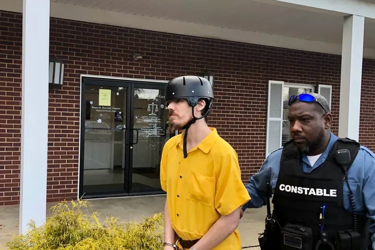 Thadius McGrath, 35, is escorted out of a district court in Northampton Township after his preliminary hearing Thursday.