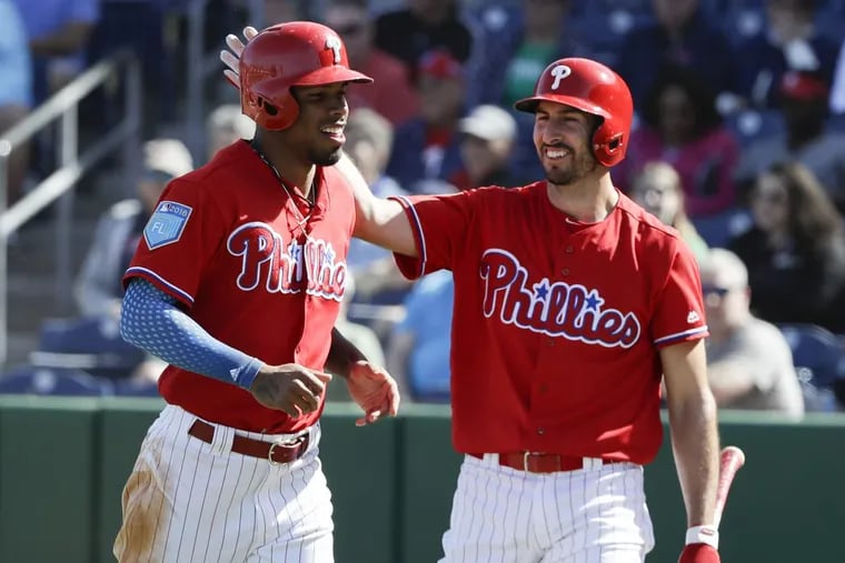 Phillies Nick Williams gets a tap from teammate Adam Rosales after Williams scored in the seventh-inning against the Boston Red Sox during a spring training game.