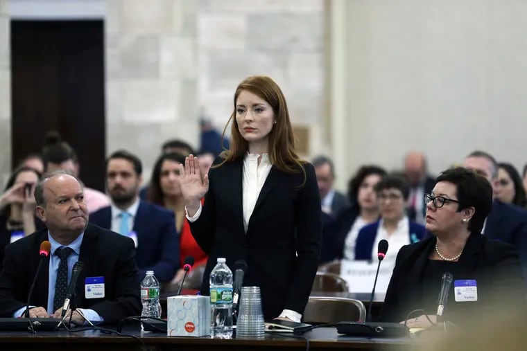 FILE- In this Dec. 4, 2018 file photo, Katie Brennan, the chief of staff at the New Jersey Housing and Mortgage Finance Agency, raises her hand as she is sworn-in to testify before the Select Oversight Committee at the Statehouse, in Trenton, N.J. On Wednesday, Jan. 23, 2019, the Middlesex County Prosecutor's office said that it would not be filing charges against Albert Alvarez, whom Brennan accused of sexually assaulting her in 2017, when they were both working to get Gov. Phil Murphy elected, citing "a lack of credible evidence." (AP Photo/Mel Evans, File)